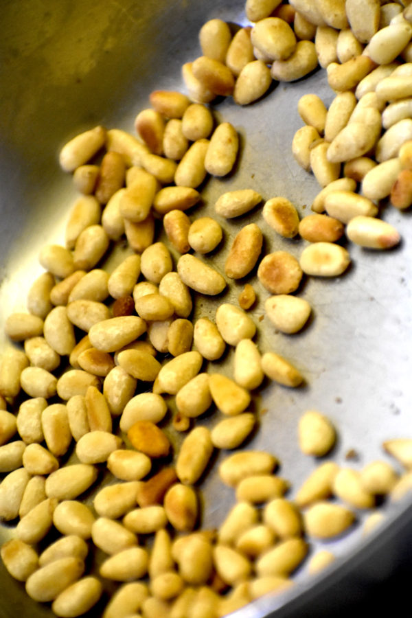 pine nuts toasting in a pan