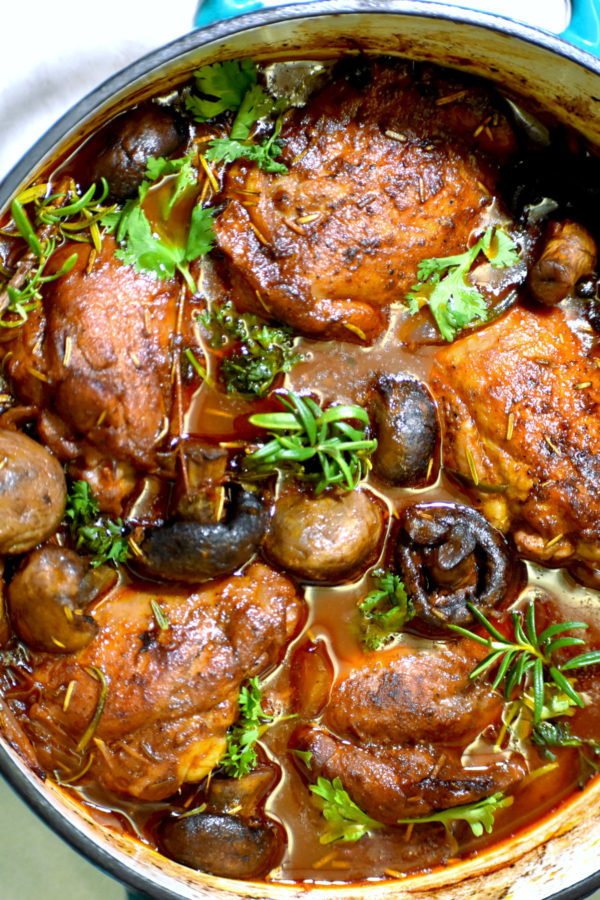 the pot of our braised chicken after coming out of the oven and garnished with more fresh herbs