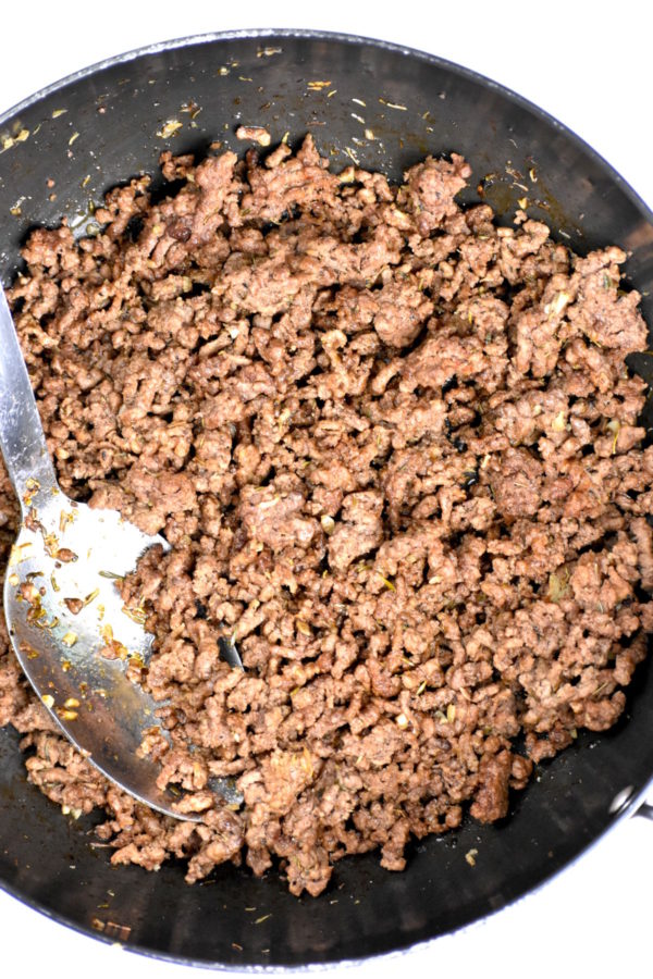 Ground beef cooking in a skillet.